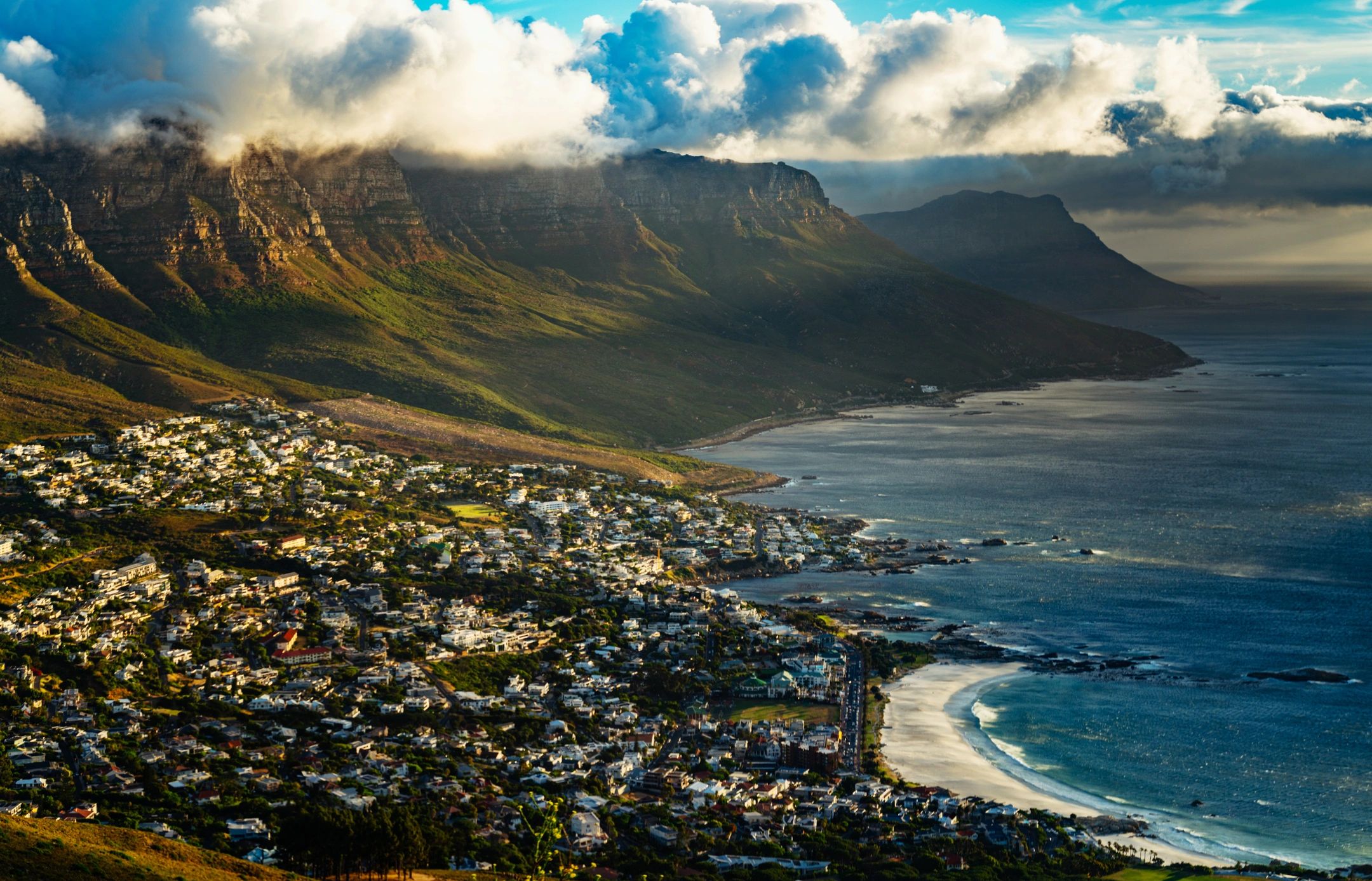 Aerial coastline with mountain backdrop